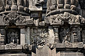 Prambanan - Candi Lara Jonggrang, miniature shrines surmounted by small fluted stupa with panels with musicians and dancers decorating the top of the balustrade 